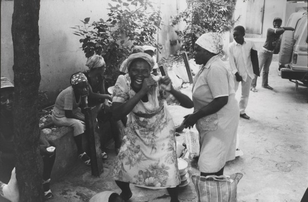 Women that sell food outside the Copa Club reenact the attacks upon the Tontons Macoute