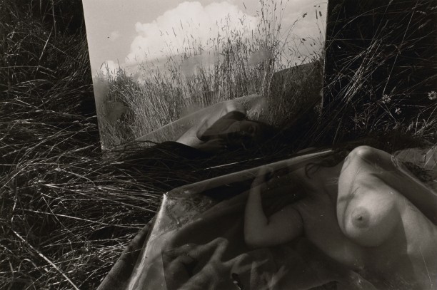 Untitled: Woman Looking At Her Reflection Under Plastic