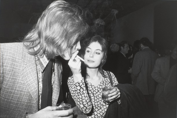Untitled (Woman holding a cigarette while a man takes a puff)