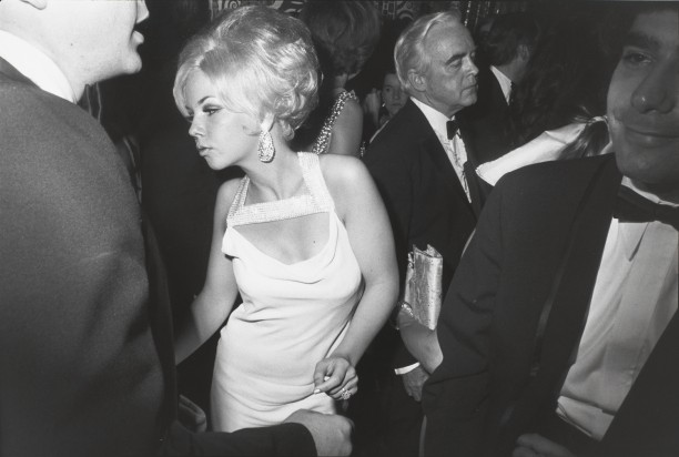 Untitled (Blond woman dancing, she has a rhinestone studded collar on her dress)