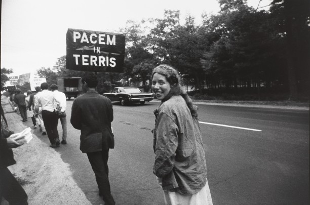 Untitled (Woman walking behind a sign